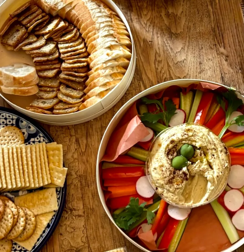 A close-up of a beautifully arranged charcuterie board with a variety of cheeses, meats, and accompaniments.